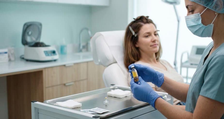 Doctor holding a vial of platelet-rich plasma before a PRP hair treatment session for thinning hair